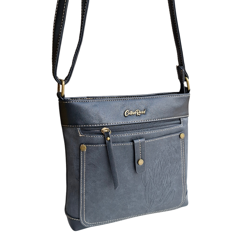 Cotton Road Sling Bag: BLACK PU Leather with Embossed Protea