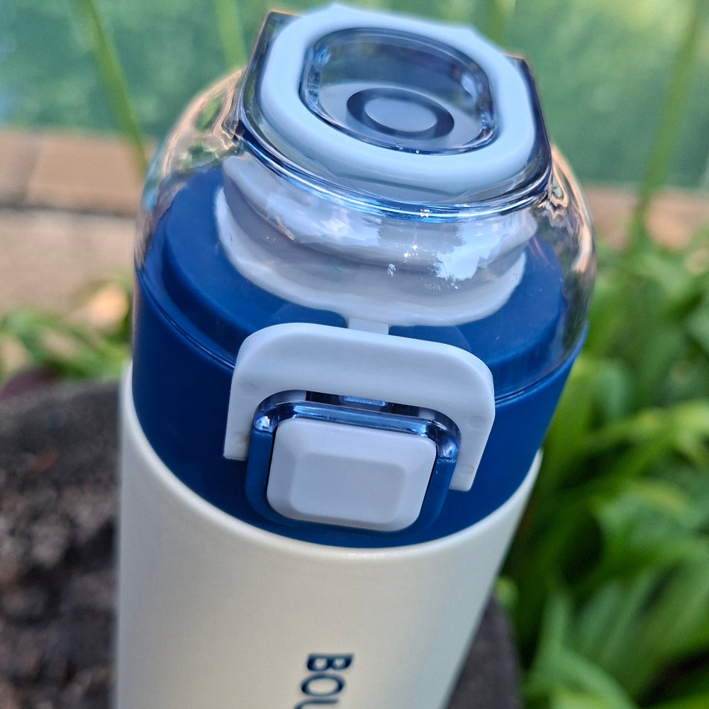 Press-button flip-top lid with safety lock on 500ml blue stainless steel thermal water bottle