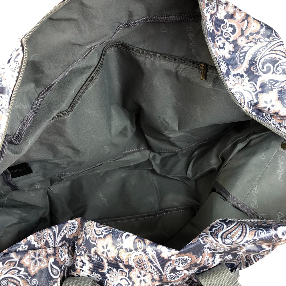 Interior view of blue PVC foldaway weekender travel bag with paisley print showing spacious main compartment and zip pockets