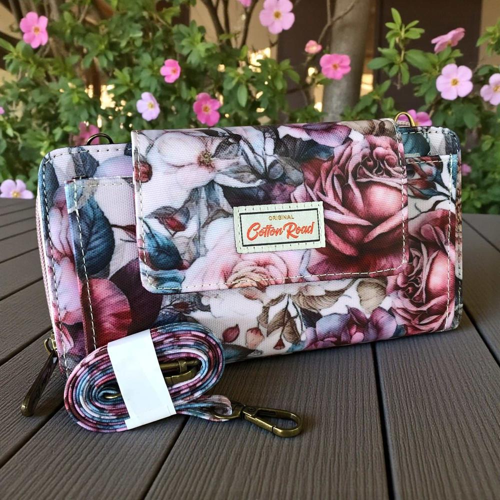 Cotton Road Wallet: Large PINK FLORAL PVC Cellphone Sling Wallet on table with sling band