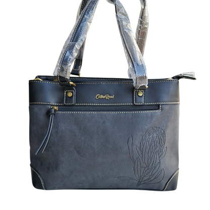 Cotton Road Handbag: BLACK PU Leather Double Compartment Handbag with EMBOSSED Protea FRONT