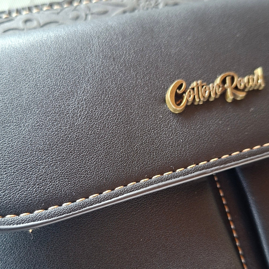 Cotton Road Sling Bag: BLACK PU Leather Crossbody with Embossed Flowers and BRANDED STRAP DETAIL
