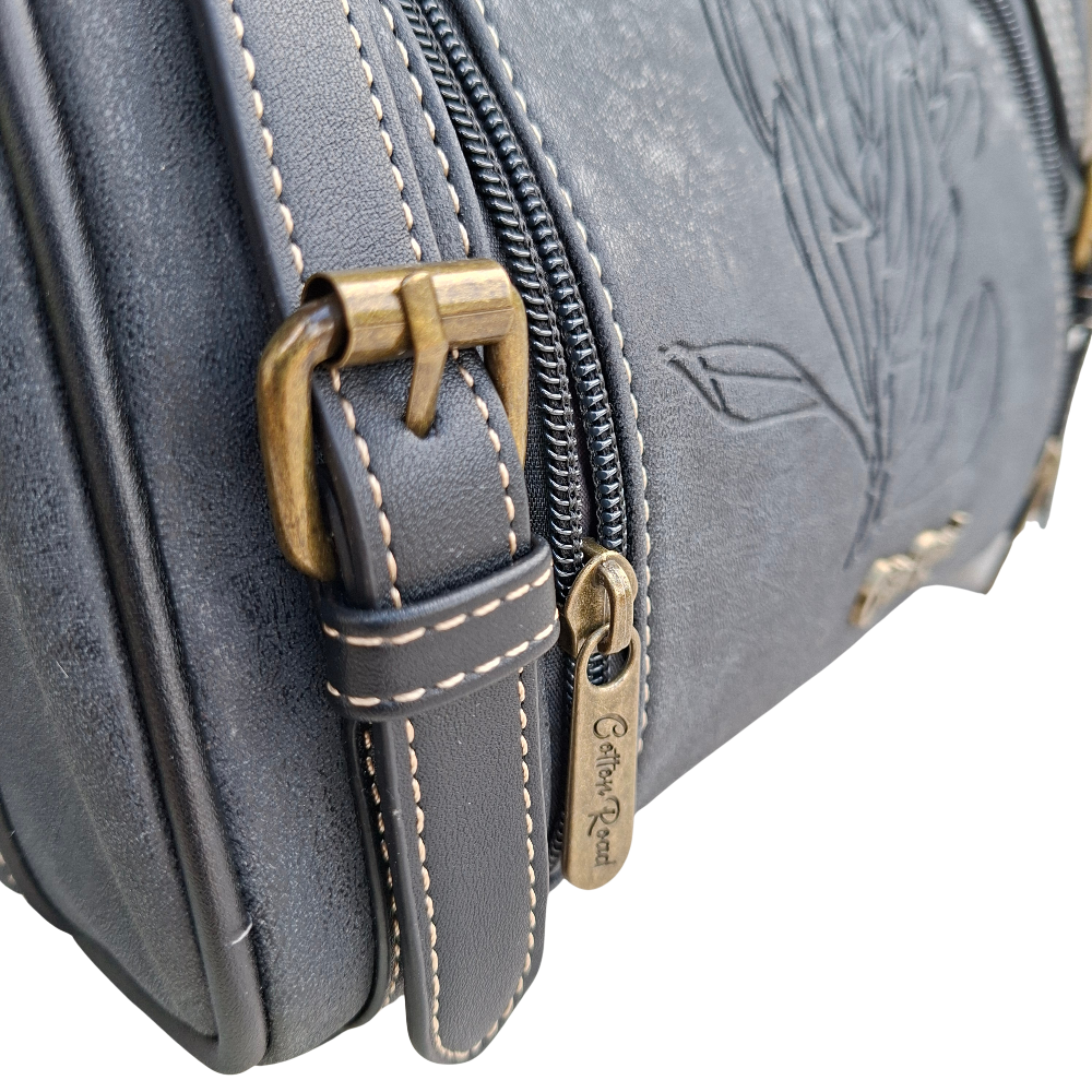 Cotton Road Sling Bag: BLACK PU Leather with Embossed PROTEA and BRANDED Strap FRONT DETAIL