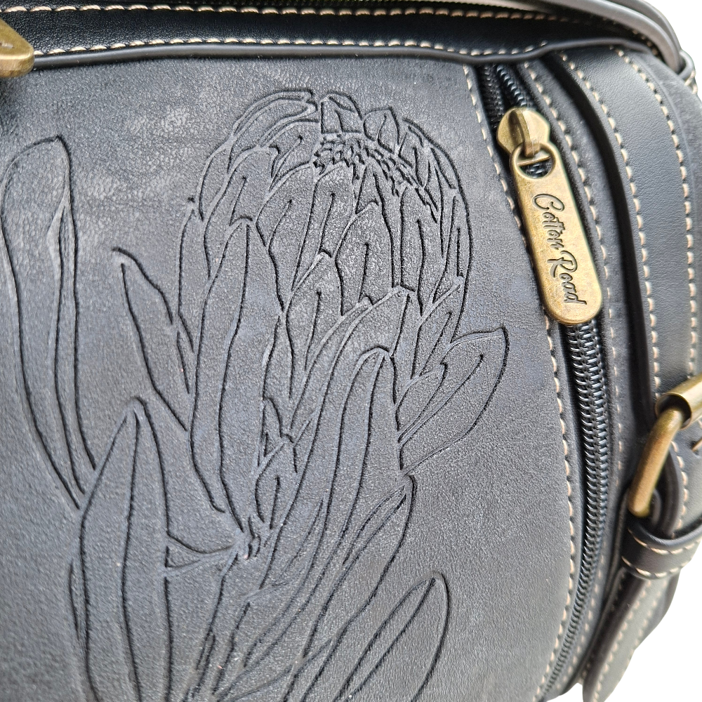 Cotton Road Sling Bag: BLACK PU Leather with Embossed PROTEA and BRANDED Strap ZOOM