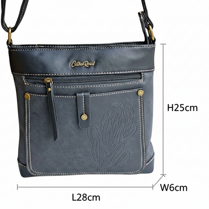 Cotton Road Sling Bag: BLACK PU Leather with Embossed Protea size