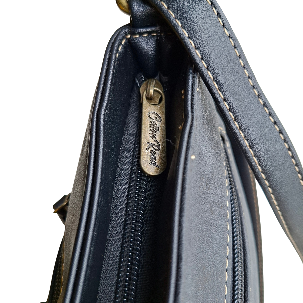 Cotton Road Sling Bag: BLACK PU Leather with Embossed Protea top zip view