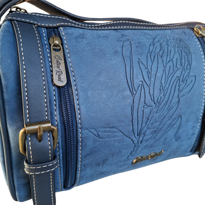 Cotton Road Sling Bag: BLUE PU Leather with Embossed PROTEA and BRANDED Strap DETAILING