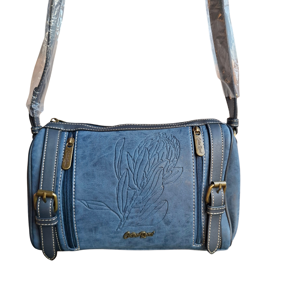 Cotton Road Sling Bag: BLUE PU Leather with Embossed PROTEA and BRANDED Strap HANGING