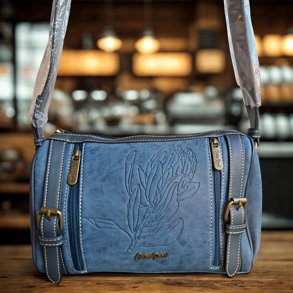 Cotton Road Sling Bag: BLUE PU Leather with Embossed PROTEA and BRANDED Strap HERO