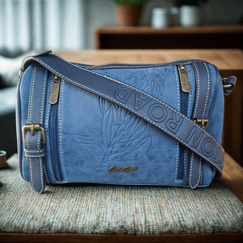 Cotton Road Sling Bag: BLUE PU Leather with Embossed PROTEA and BRANDED Strap LIFESTYLE