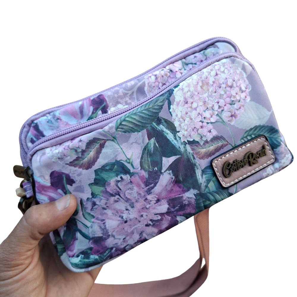 Cotton Road Sling Bag: LILAC FLORAL Canvas Mini Sling Bag in hand