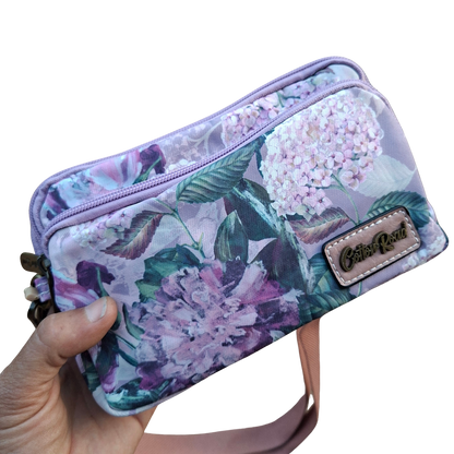 Cotton Road Sling Bag: LILAC FLORAL Canvas Mini Sling Bag in hand