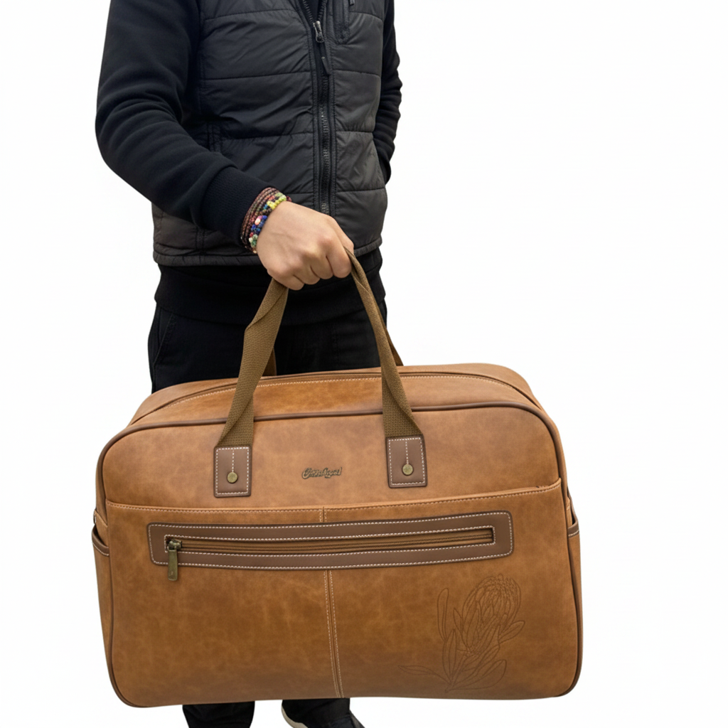 Cotton Road Travel Bag: BROWN PU Leather Overnight Duffel with Embossed Protea IN HAND