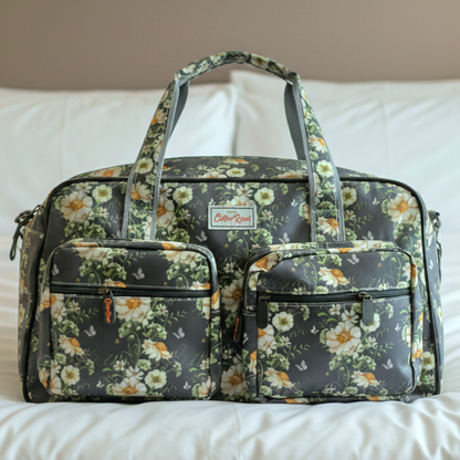 Cotton Road Travel Bag: DARK GREY Overnight Bag with IVORY FLOWERS on white bed