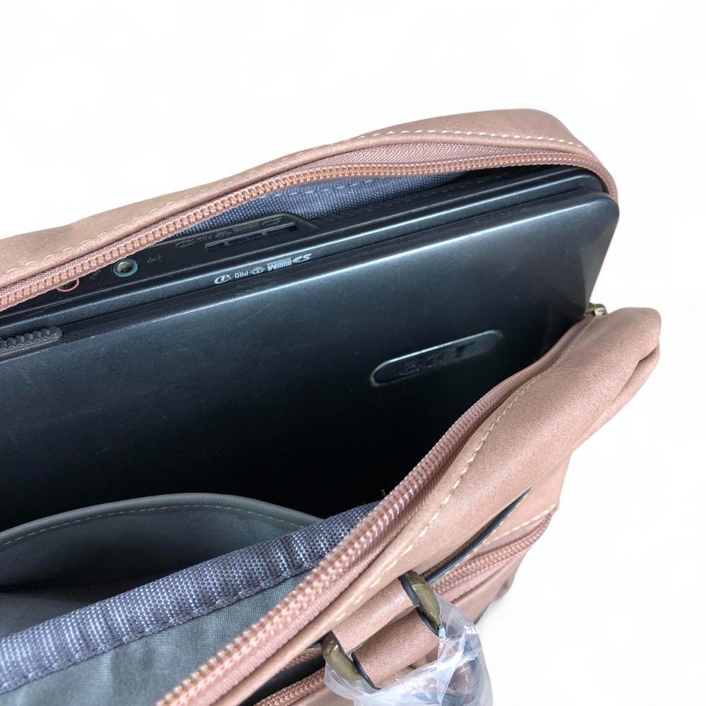 Pink PU leather laptop bag with padded compartment fitting 15.6" laptop, twin handles, and adjustable shoulder strap.