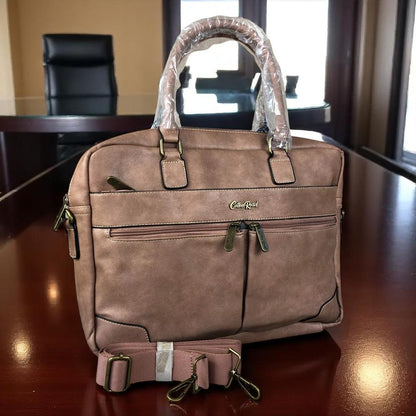 Pink PU leather laptop bag with twin handles, adjustable shoulder strap, padded compartment for 15.6" laptop, multiple zippered pockets, and trolley strap.