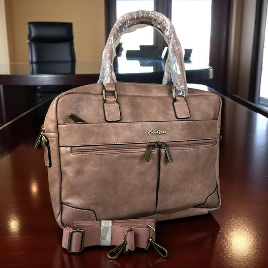 Pink PU leather laptop bag with twin handles, adjustable shoulder strap, padded compartment for 15.6" laptop, multiple zippered pockets, and trolley strap.