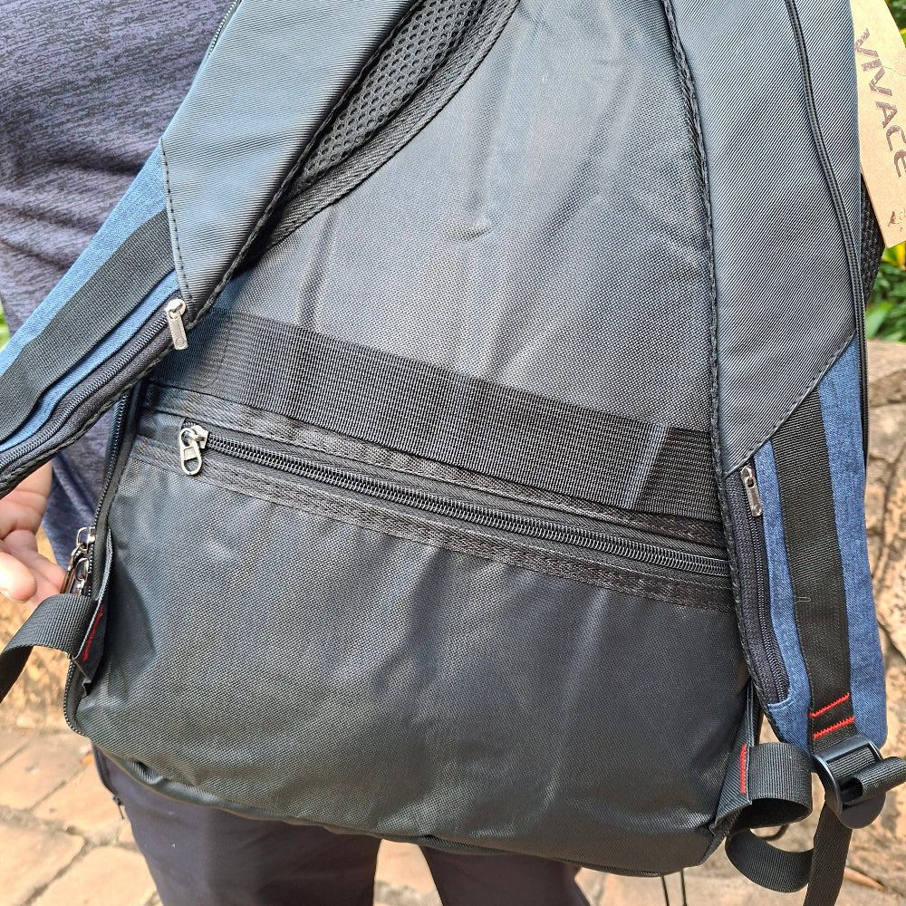 Close-up of a gray and blue backpack back view that fits against your back with secure zipped pockets.