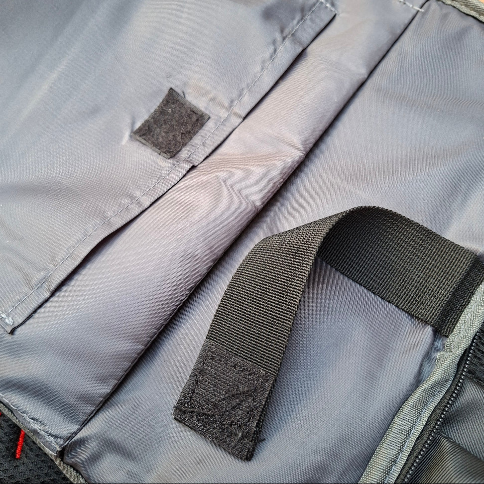 Close-up of padded pockets with a black strap used to secure laptop in the Vivace Blue Travel Backpack