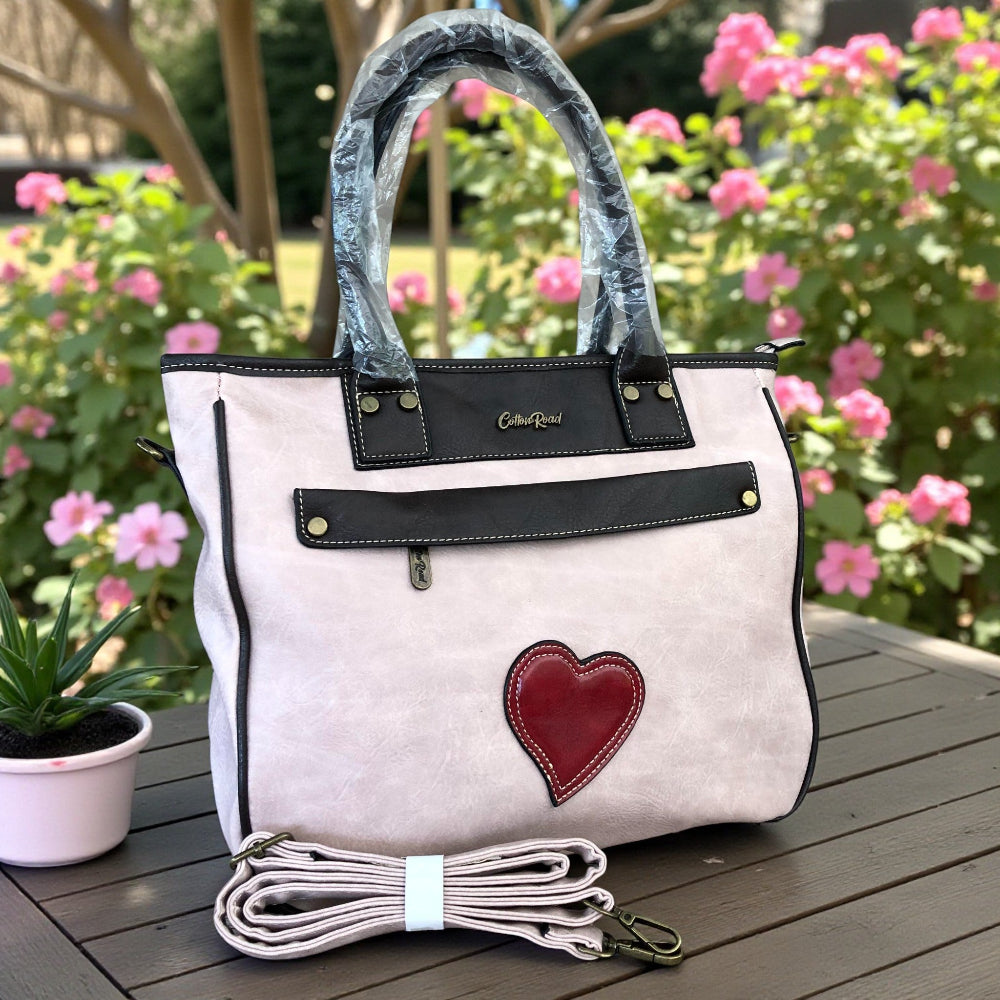 Cotton Road pale pink PU leather handbag front view on table