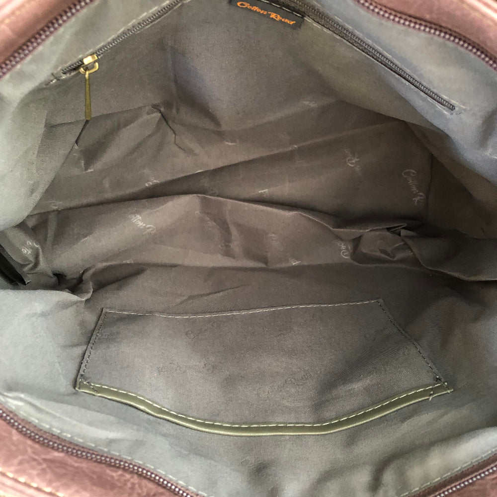 Close-up of a Cotton Road Purple handbag interior with visible stitching and a brand label.