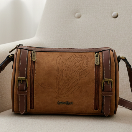 Cotton Road Sling Bag: BROWN PU Leather Sling Bag with Protea detailing and BRANDED Strap