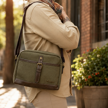 Cotton Road Sling Bag Green Canvas with PU Leather trim with brown adjustable strap on a female model in a suburban landscape background 