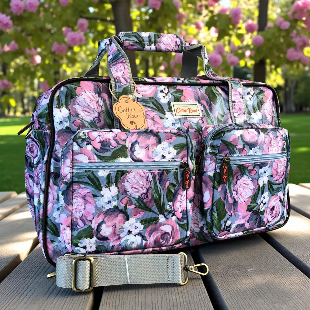 Cotton Road Travel Bag: BLUE PVC Overnight Travel Bag with PINK PURPLE FLOWERS in garden