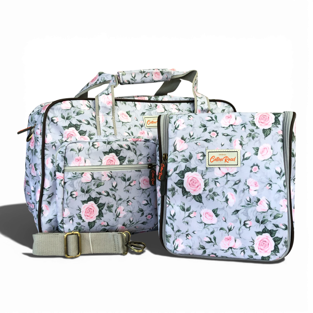 Grey Cotton Road travel bag with pink rose design and matching vanity bag in durable PVC material