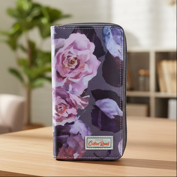 Large purple floral PVC Cotton Road wallet with multiple compartments and card slots standing on a table