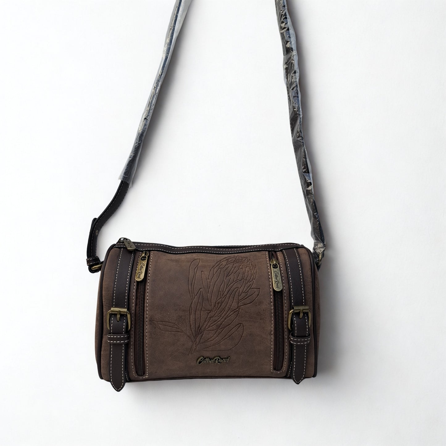 Cotton Road Sling Bag: COFFEE BROWN PU Leather Sling Bag with Protea detail