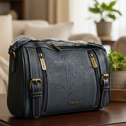 Cotton Road Sling Bag: BLACK PU Leather with Embossed PROTEA and BRANDED Strap