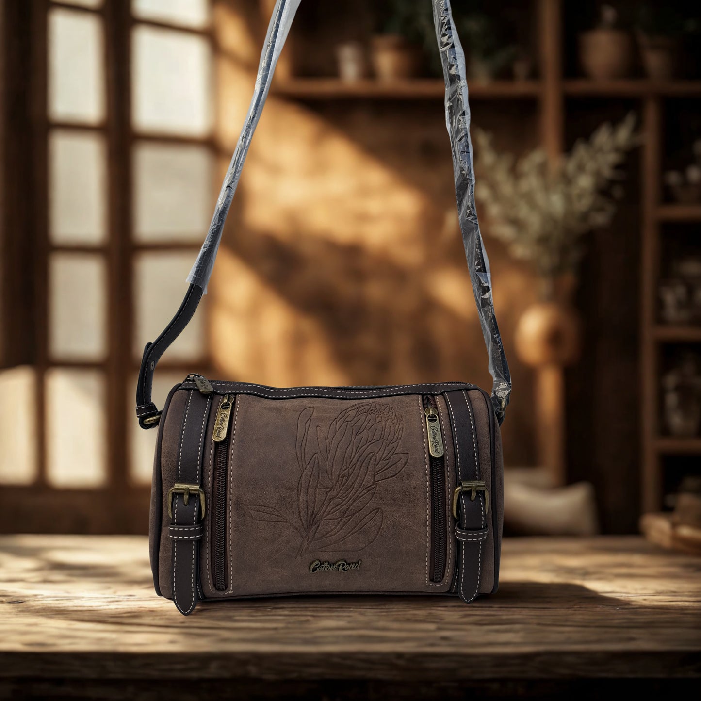 Cotton Road Sling Bag: COFFEE BROWN PU Leather Sling Bag with Protea detail