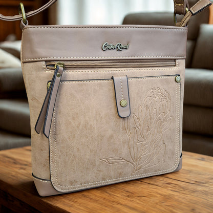 Cotton Road Sling Bag: KHAKI PU Leather with Embossed Protea