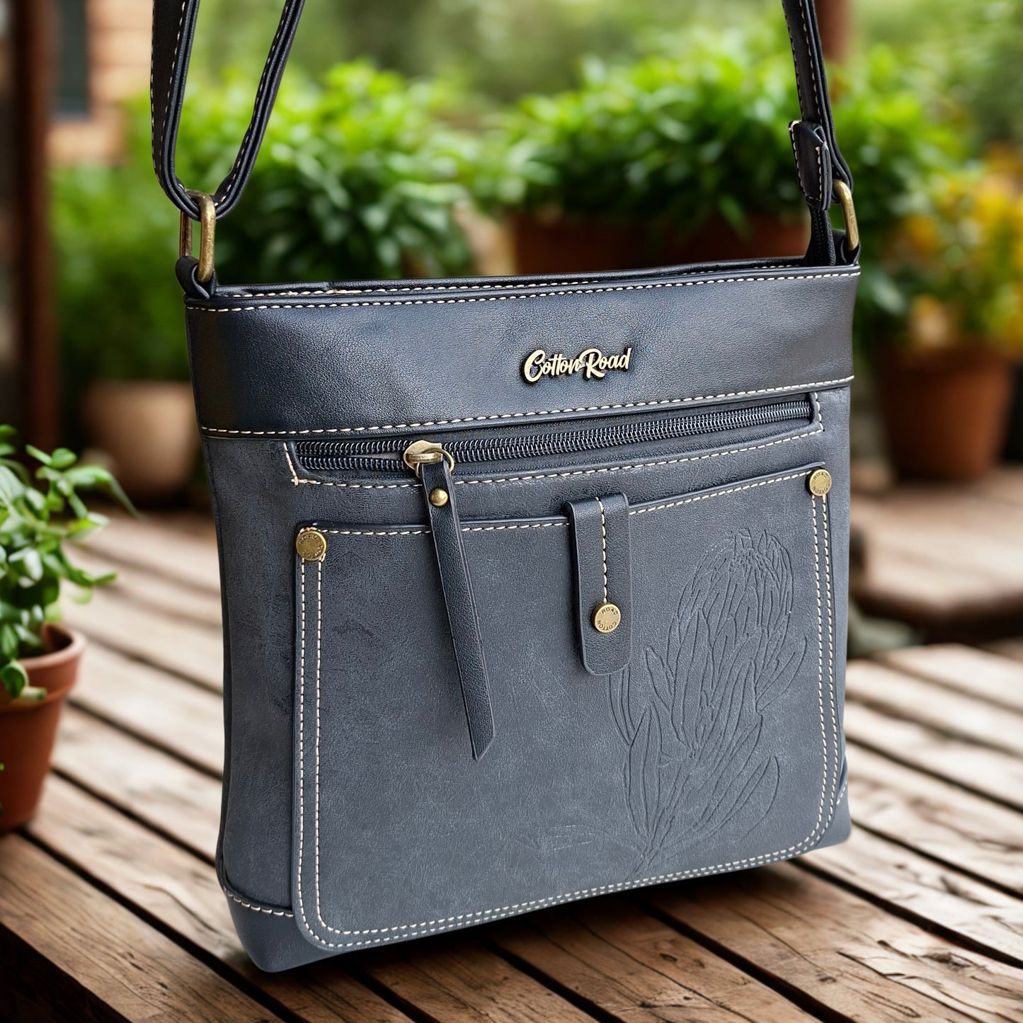 Cotton Road Sling Bag: BLACK PU Leather with Embossed Protea