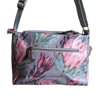 Cotton Road Sling Bag: GREY PVC Triple pocket Sling with Protea print