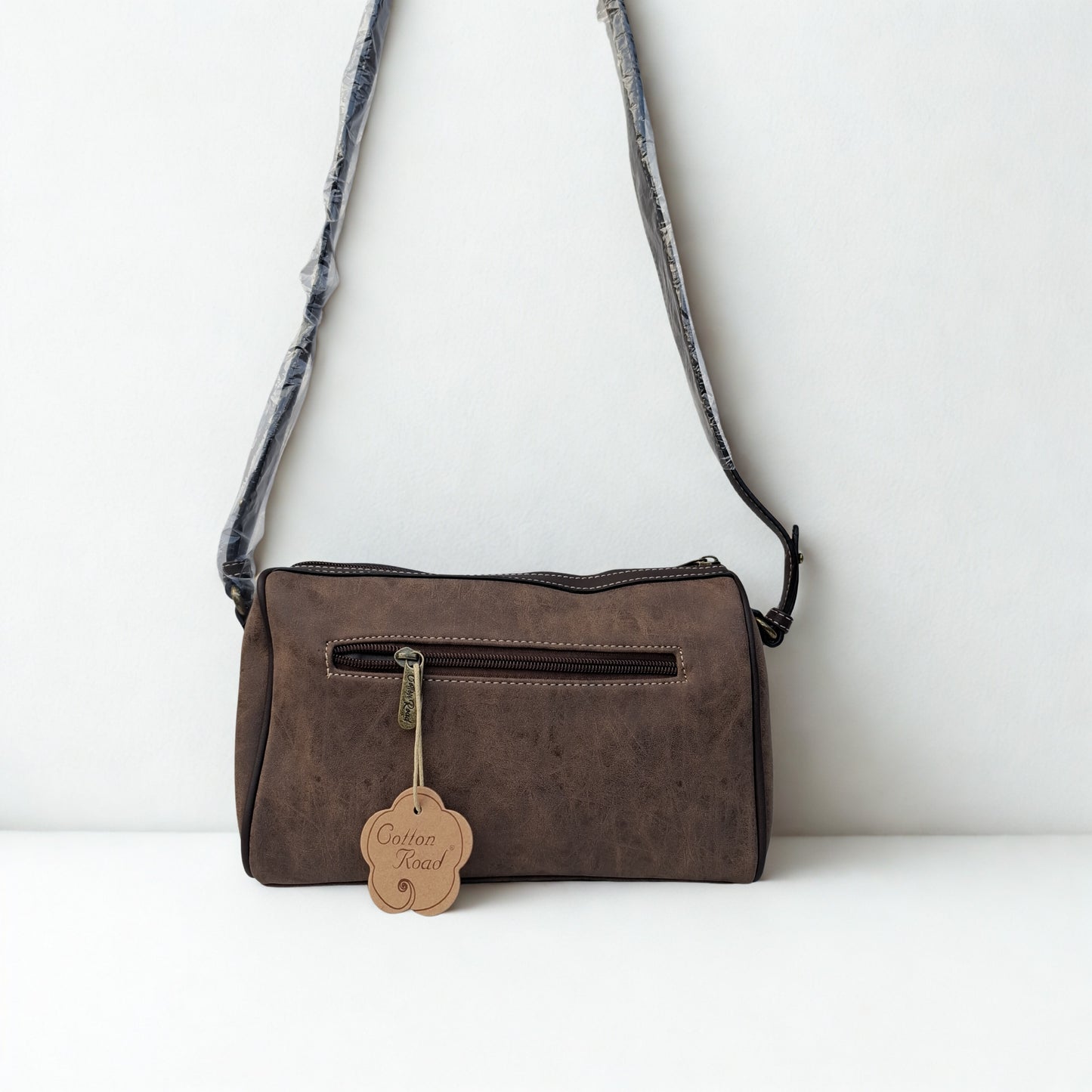 Cotton Road Sling Bag: COFFEE BROWN PU Leather Sling Bag with Protea detail