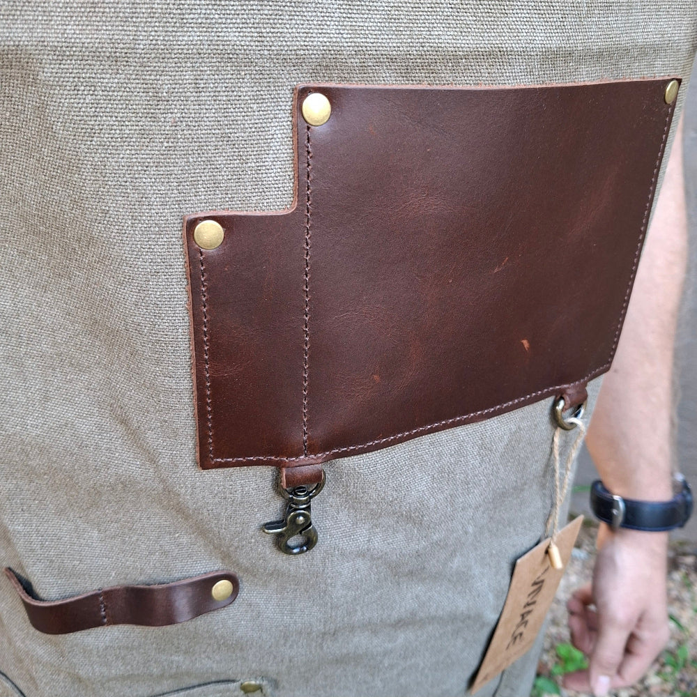 A heavy-duty vivace waxed cotton apron front leather pockets