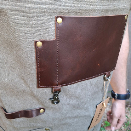 A heavy-duty vivace waxed cotton apron front leather pockets