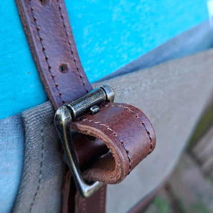 A heavy-duty vivace waxed cotton apron  front buckle on leather strap