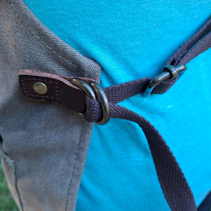 A heavy-duty vivace waxed cotton apron rear apron straps tied