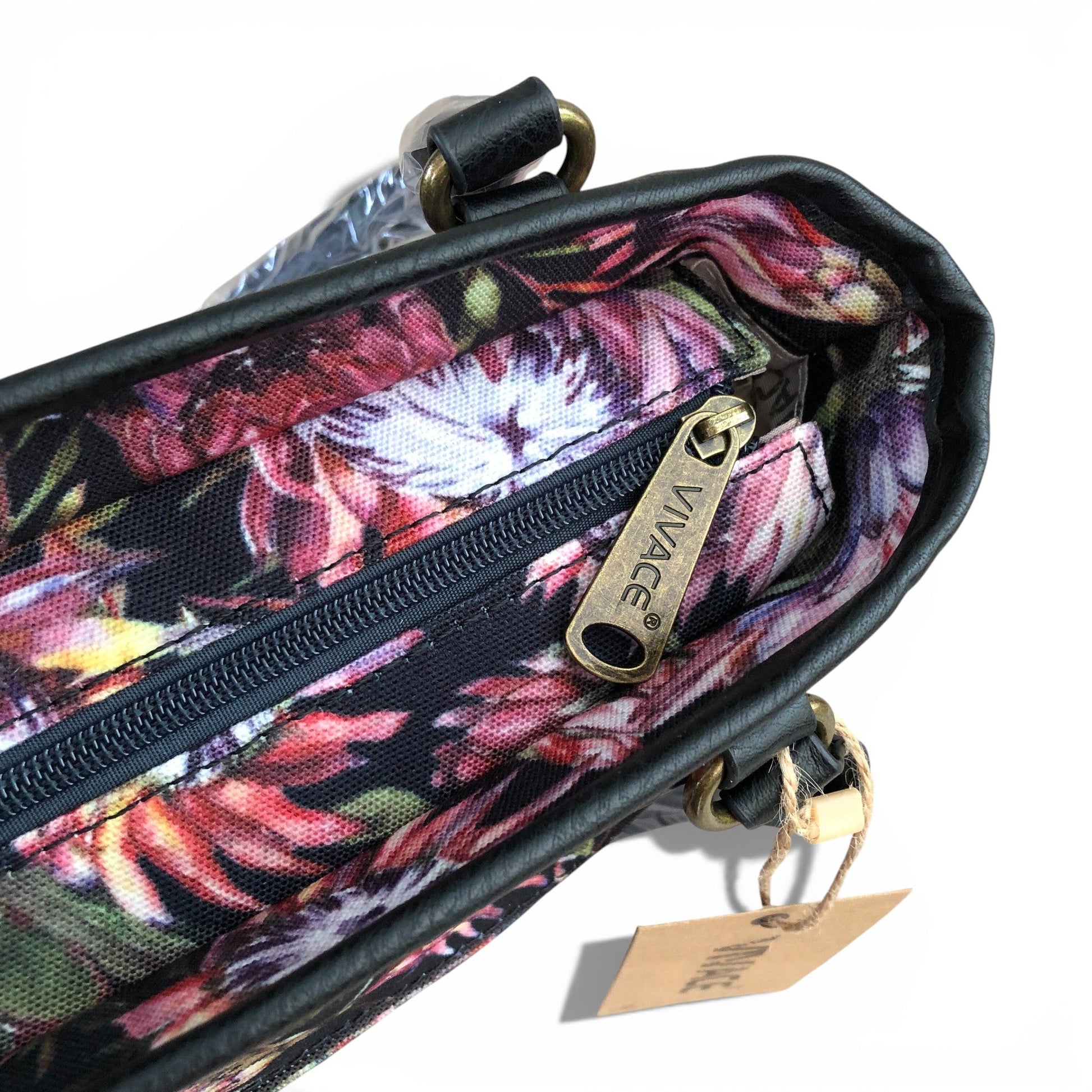 Floral patterned handbag with visible brand name on a white background