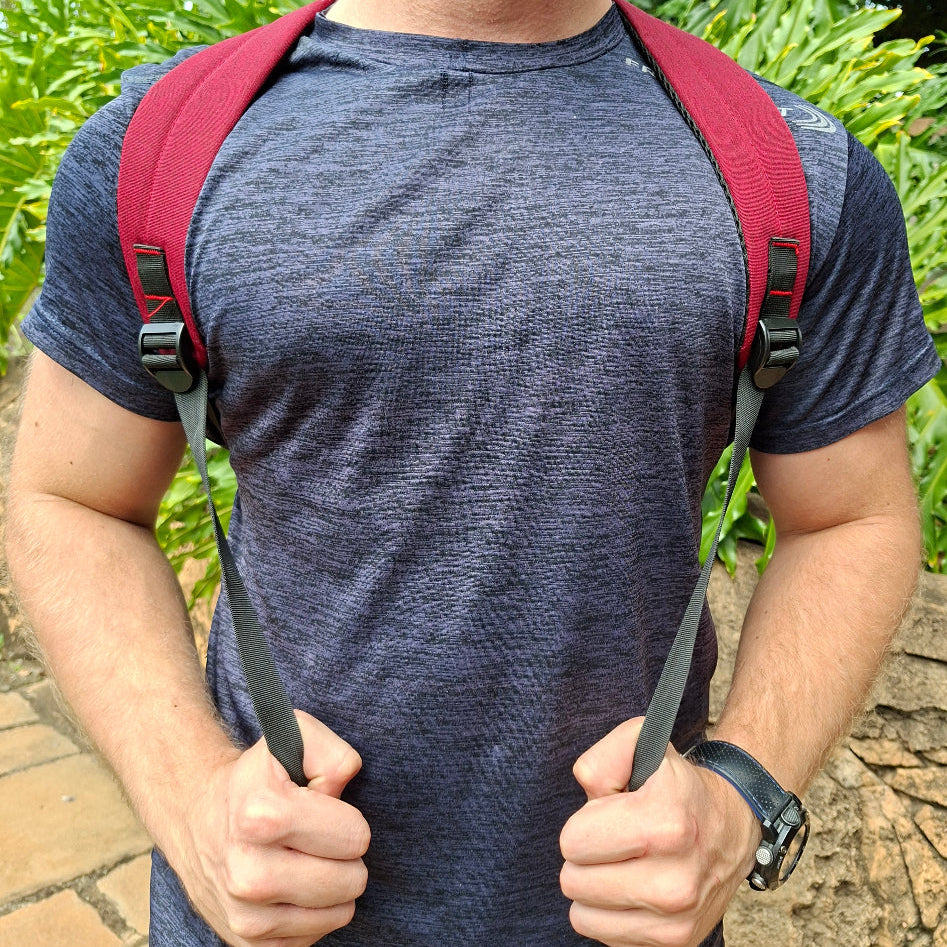 Vivace red canvas laptop backpack over the shoulder harness view from the front. 